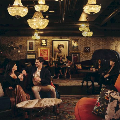 Cozy lounge with friends chatting on couches, warm lighting, mural-art walls, and vintage decor in a dimly lit social space ending with a period.