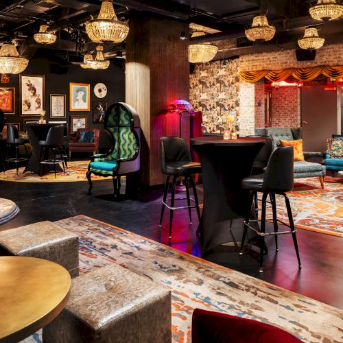 A stylish lounge or bar with warm lighting, eclectic seating, patterned rugs, chandeliers, and a cozy, artsy vibe.